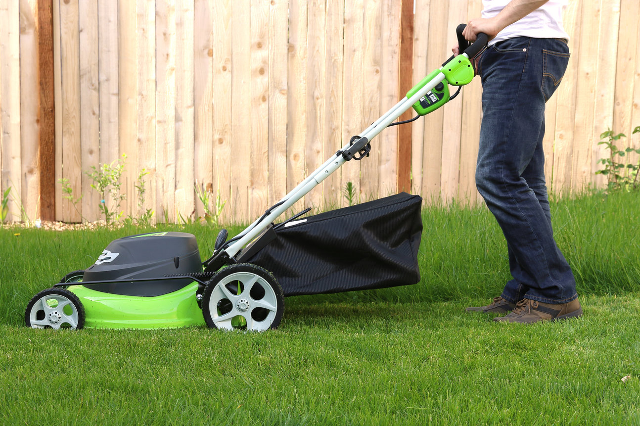 Man cutting the grass with lawn mower