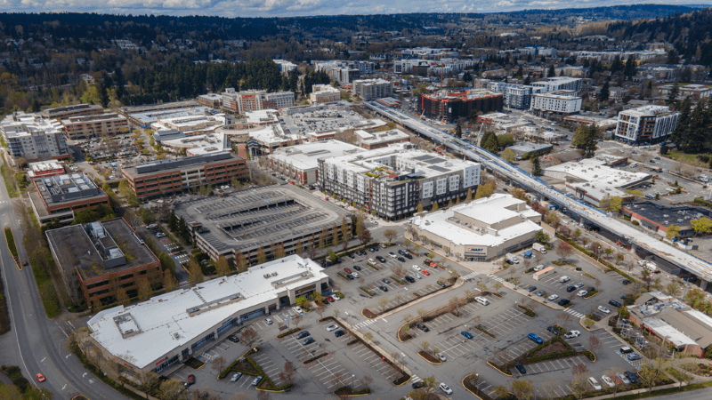 An aerial view of mixed-use development in Redmond, Washington with forests in the distance