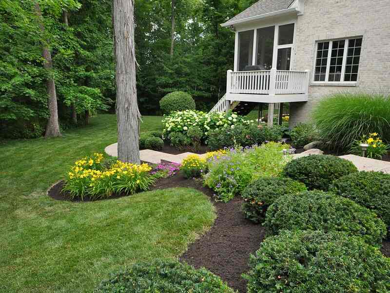 dark brown colored mulch in a well maintained lawn