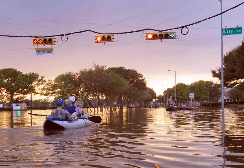 Families canoe down flooded streets in Houston