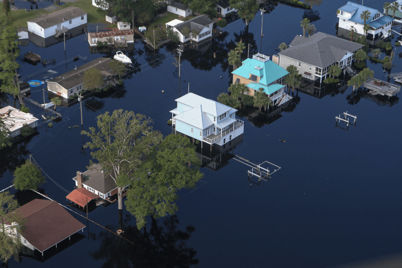 An aerial shot of residential homes and trees submerged in flood waters in Horry County, South Carolina