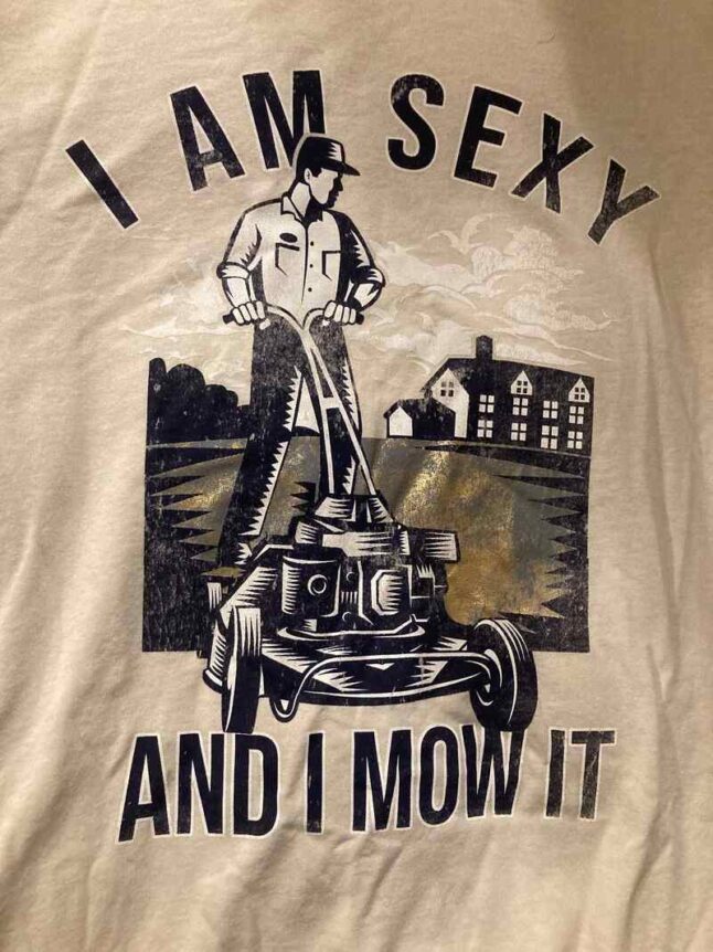 lawn mower themed t-shirt with text and person mowing lawn image over it