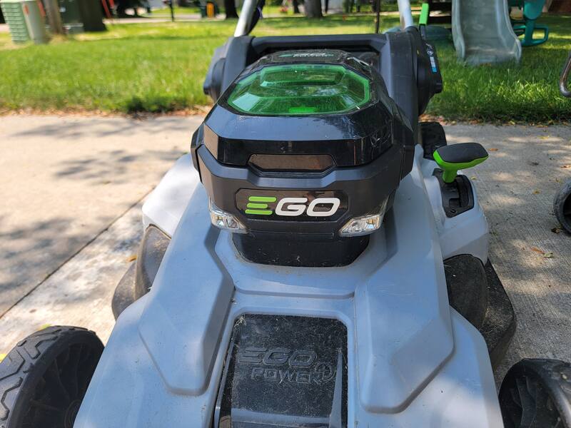 electric lawn mower showing top of mower and battery compartment