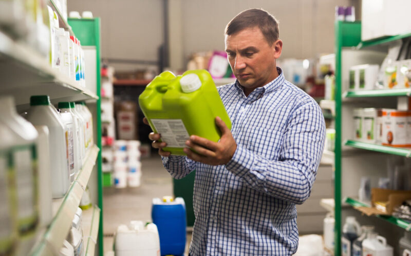 Man holding plastic gallon of liquid product