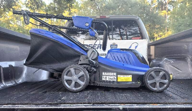 lawn mower placed on trunk of a truck