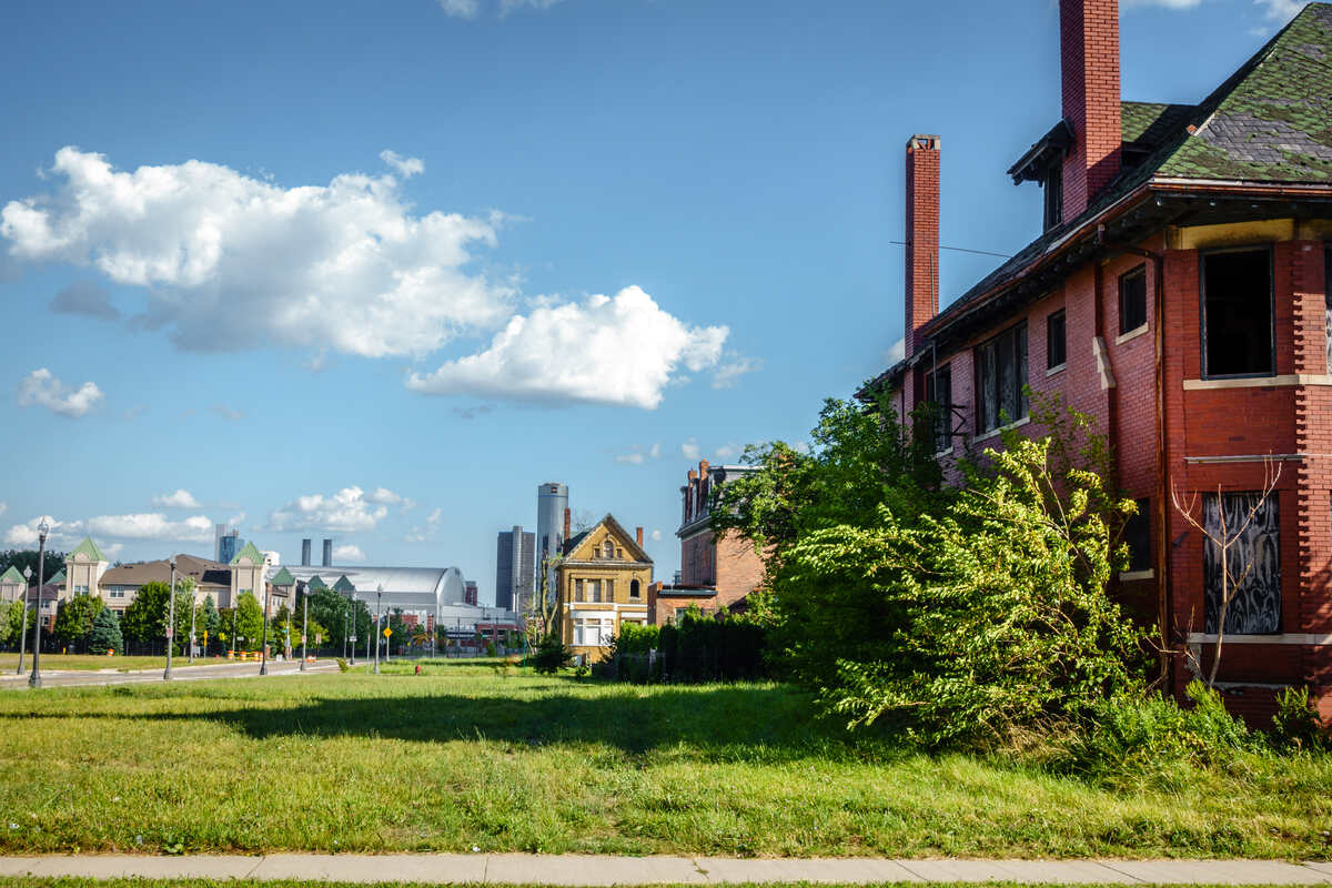 A side view of lawn in front of a house in Detroit, Michigan with the city in the background